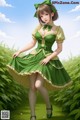 A woman in a green dress is standing in the grass.